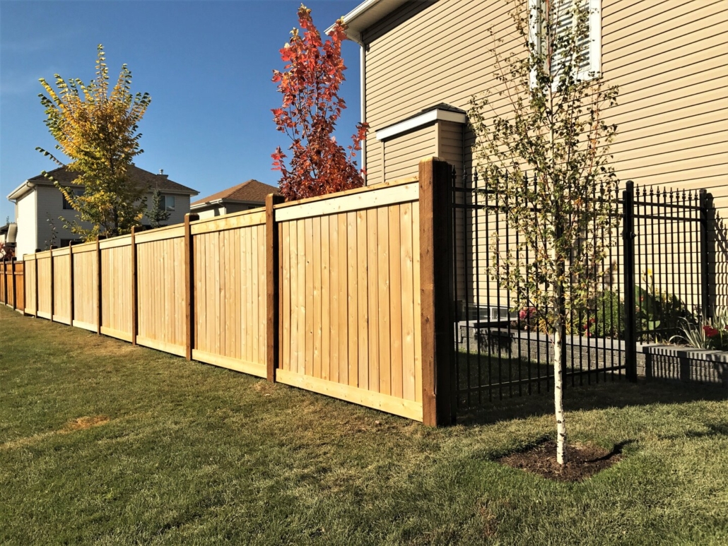Ornamental fence attached to wood fence