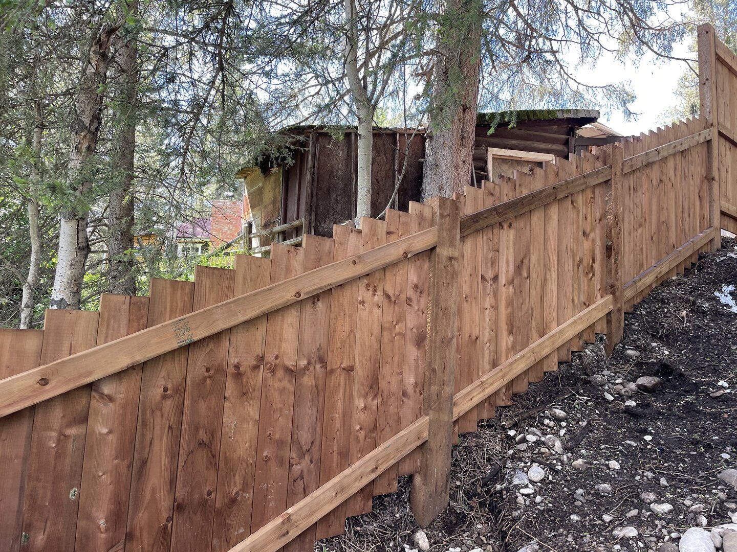 Angled wood fence on a hill