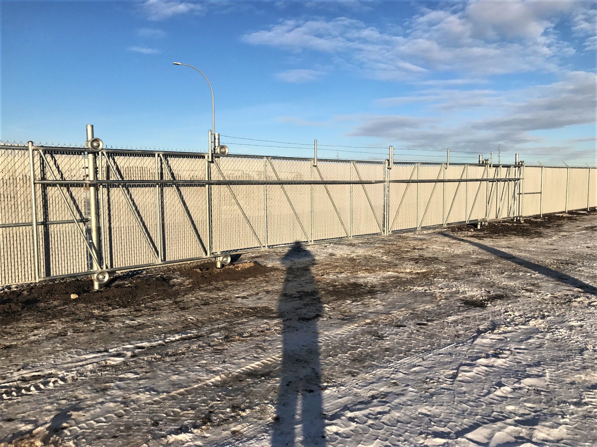 Commercial chain link fence with cantilever gate