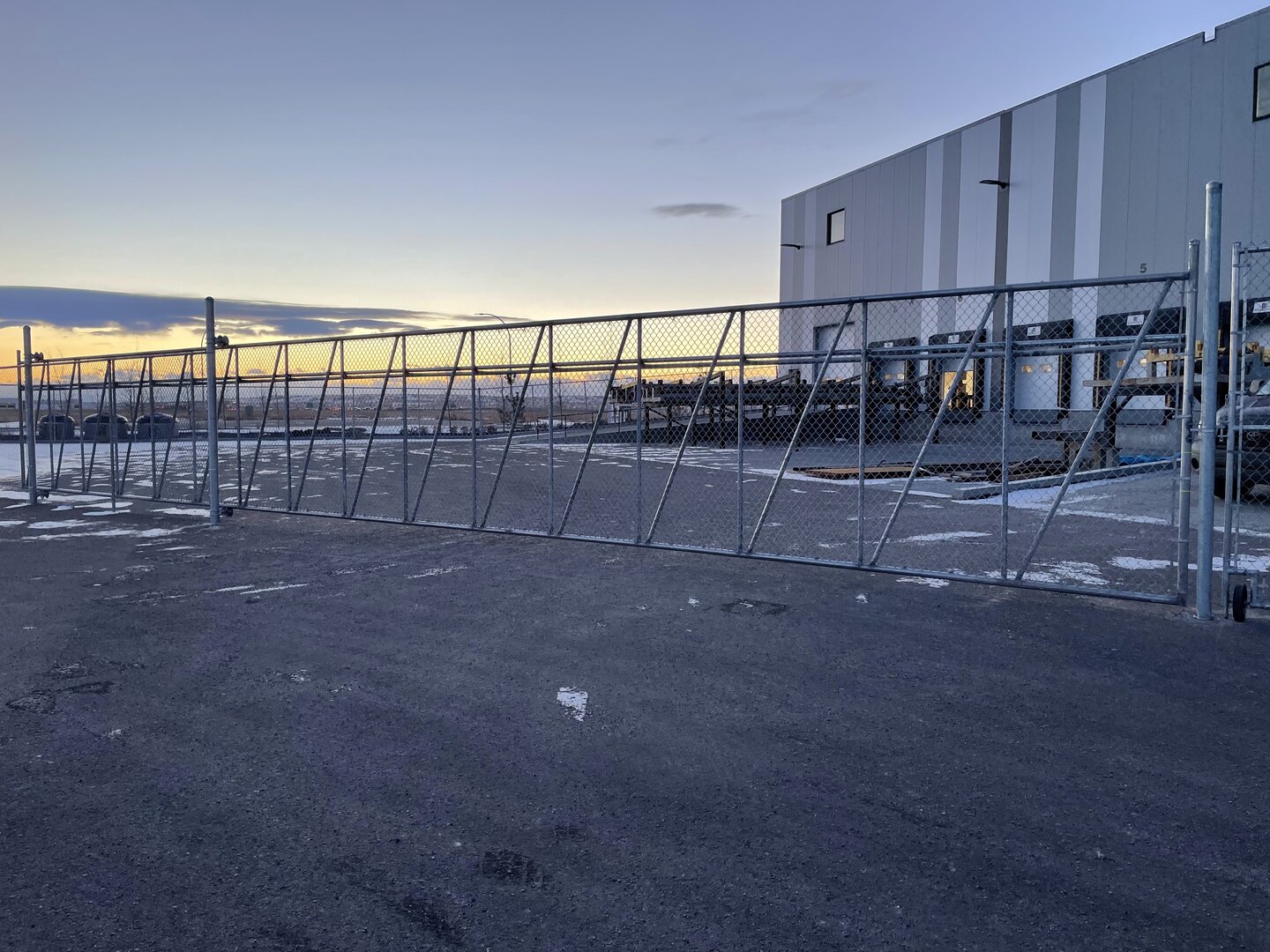 Commercial chain link fence with cantilever gate