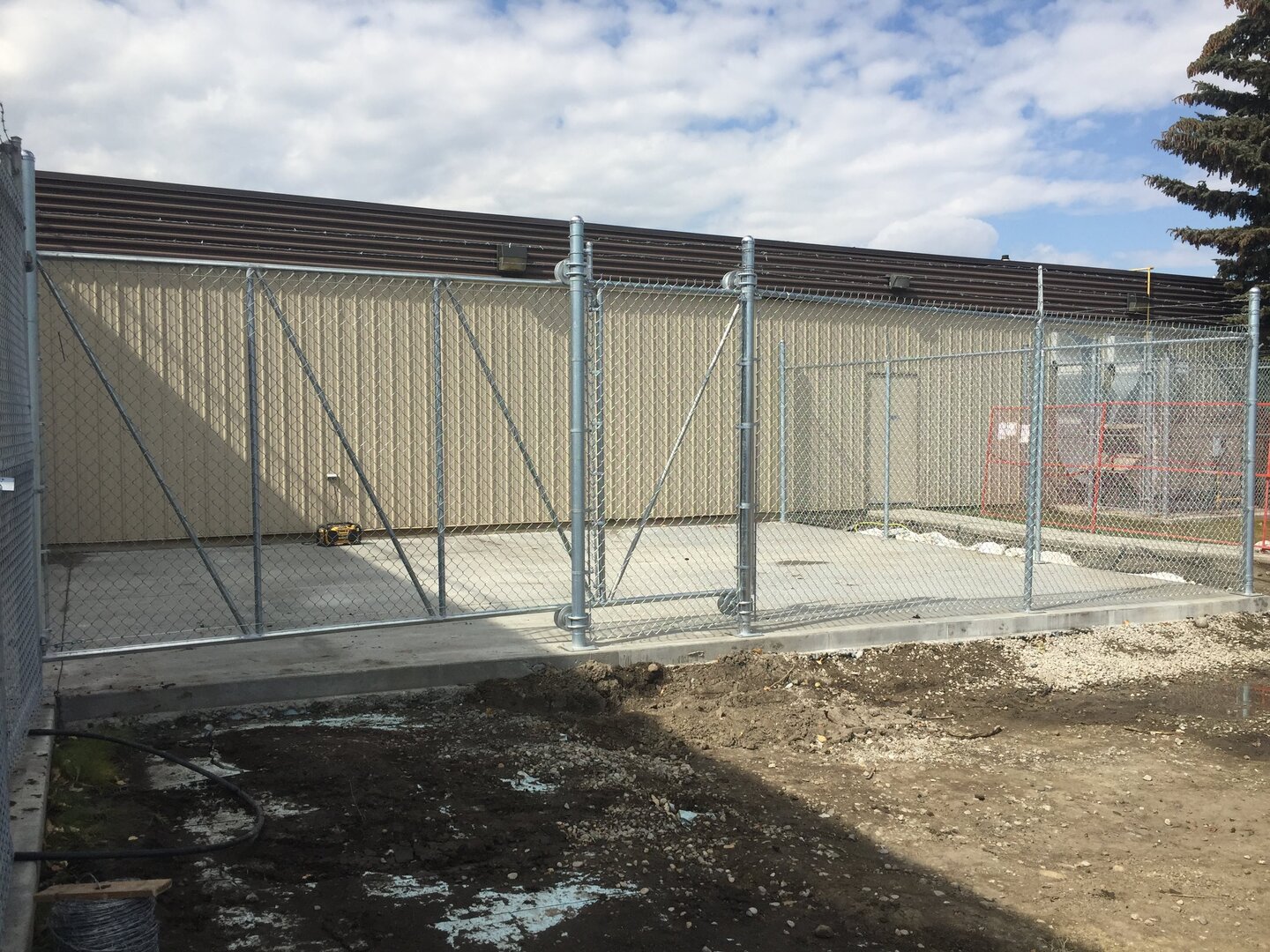 Commercial chain link fence with a cantilever gate