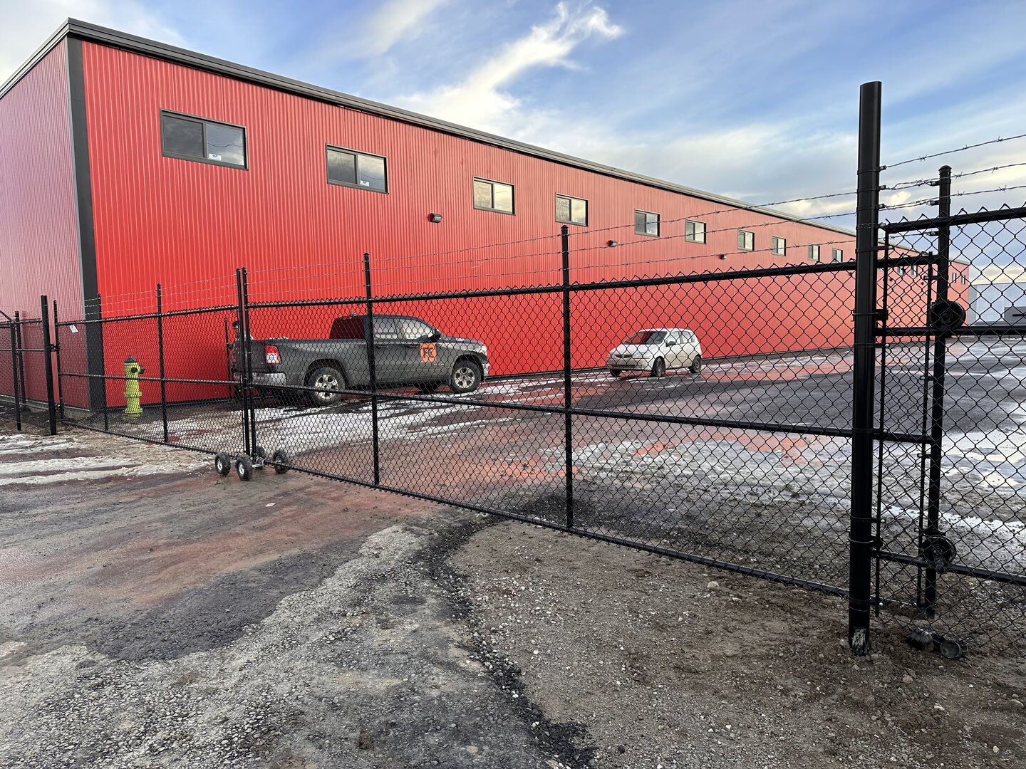 Commercial chain link fence with cantilever gate