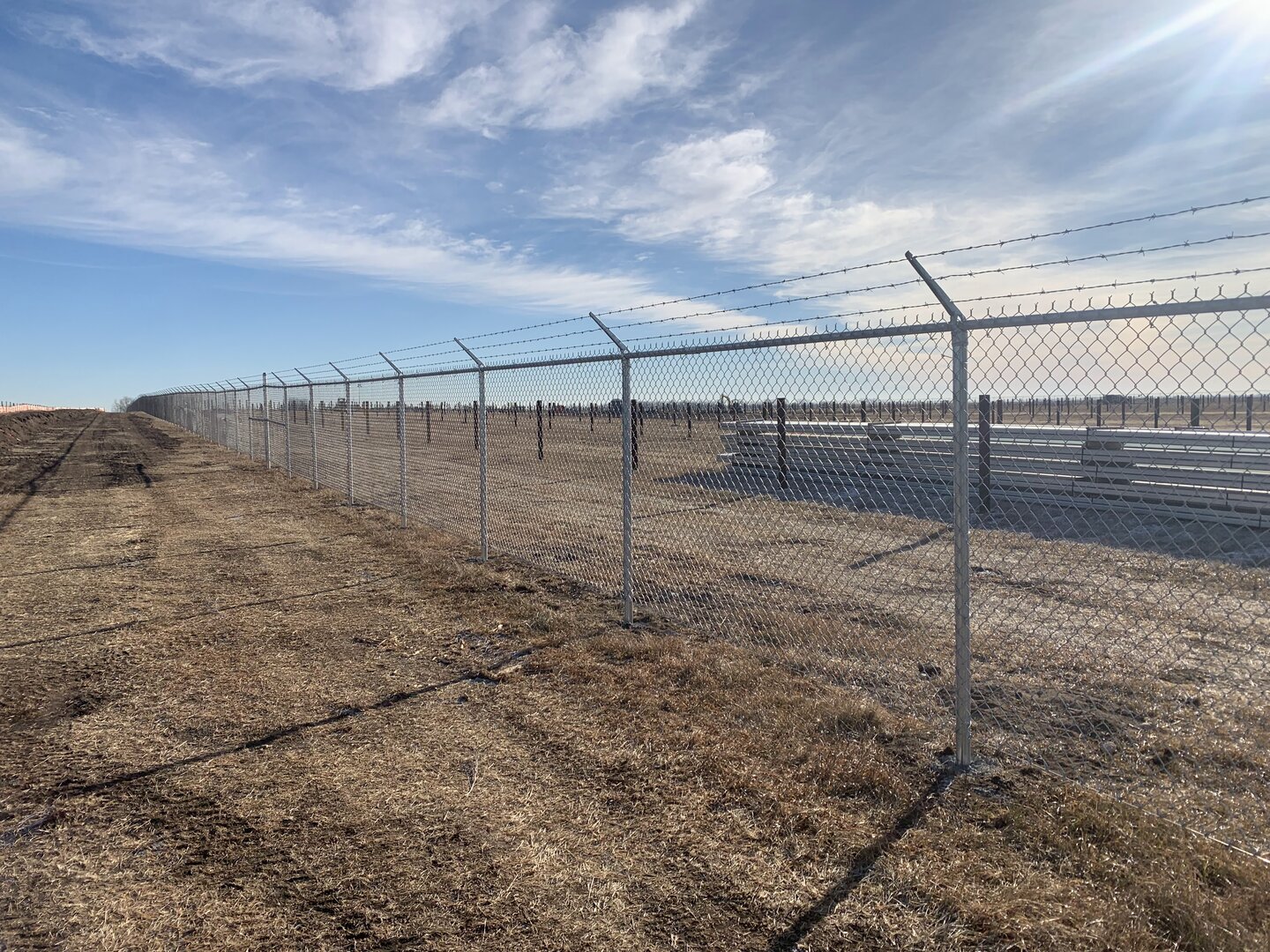 Commercial chain link fence with barbed wire