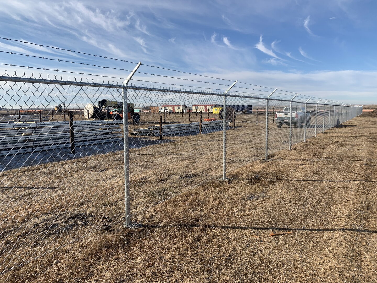 Commercial chain link fence with barbed wire