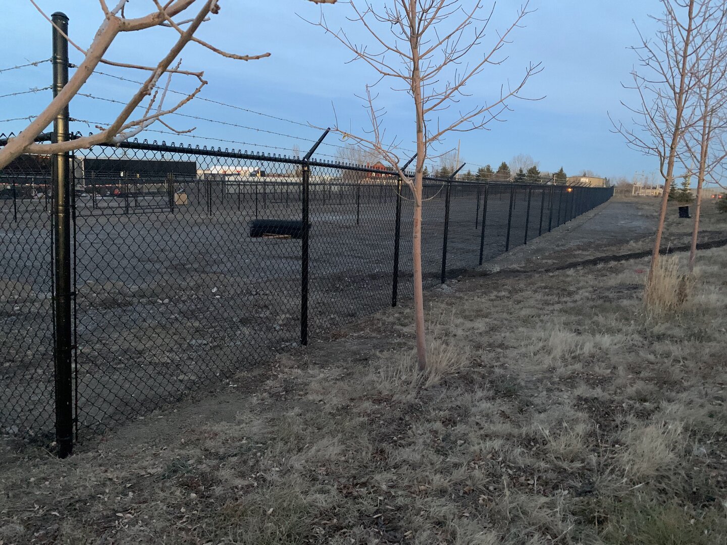 Commercial chain link fence with barbed wire