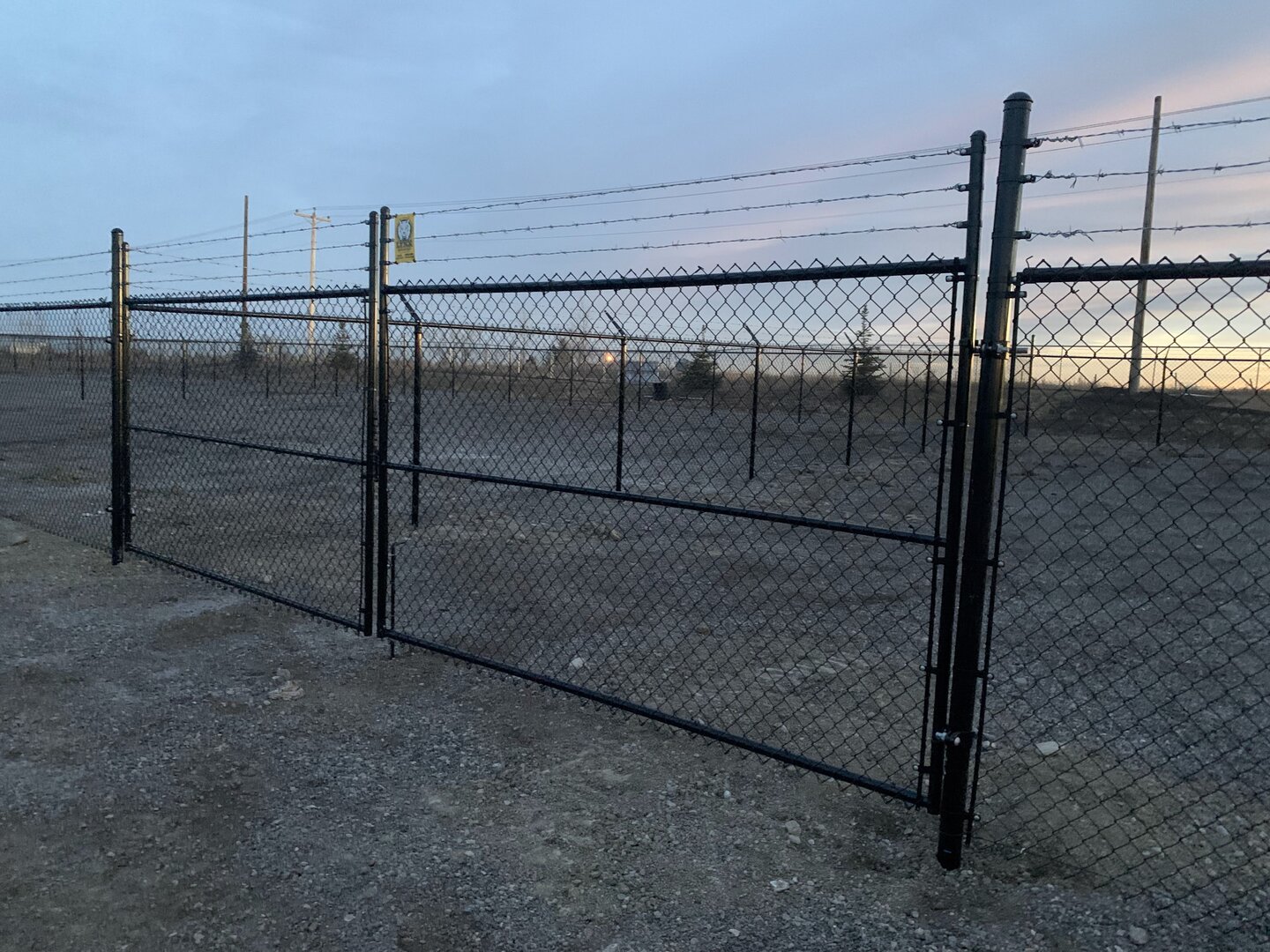 Commercial chain link fence with gate and barbed wire