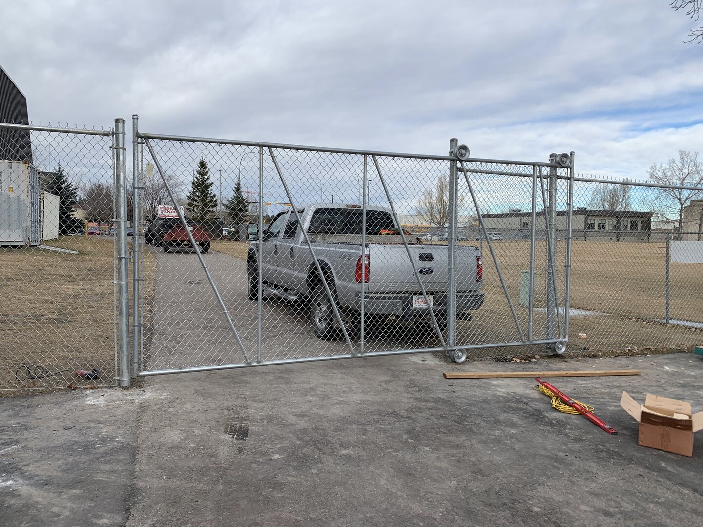 Commercial chain link fence with cantilever gate