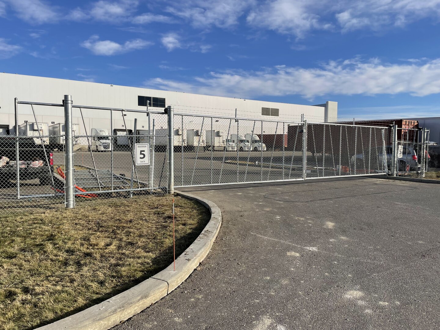Commercial chain link fence with a cantilever gate